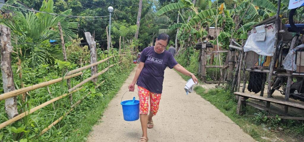 Masbate town women seek solutions as water, plastic woes strain environment 1 Facing water problems, Amalia Bartolay, 58, and the other members of Real Women's Organization have to make trips to and from water sources to be able to supply their community with fresh produce. (photo by Rey Anthony Ostria, BicoldotPH)