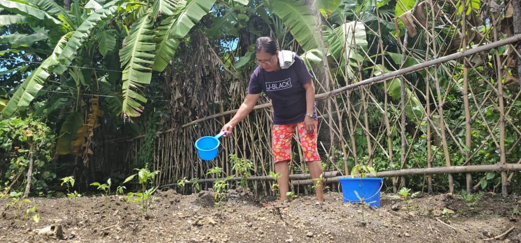 Masbate town women seek solutions as water, plastic woes strain environment 3 Facing water problems, Amalia Bartolay, 58, and the other members of Real Women's Organization have to make trips to and from water sources to be able to supply their community with fresh produce. (photo by Rey Anthony Ostria, BicoldotPH)